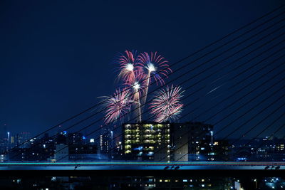 Low angle view of firework display against sky at night