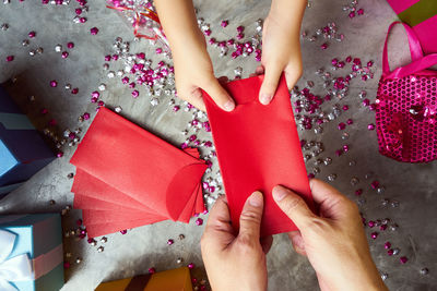 Directly above shot of hands holding envelope