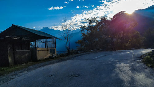 Road amidst buildings against sky during winter