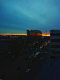 High angle view of illuminated buildings in city at dusk