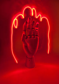 Illuminated light painting against red background