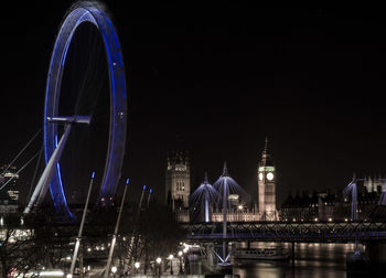 Golden jubilee bridge over thames river with illuminated london eye