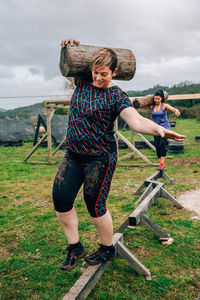 Full length of woman standing on field against sky