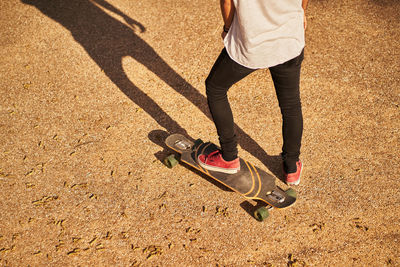 Low section of man skateboarding on skateboard