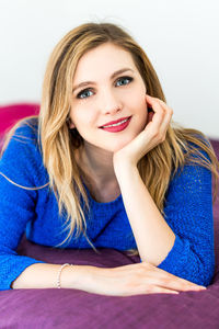 Portrait of beautiful woman against white background