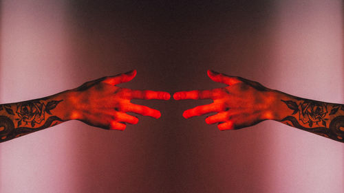 Digital composite image of hand on red background