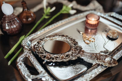 High angle view of mirror in tray with scissors