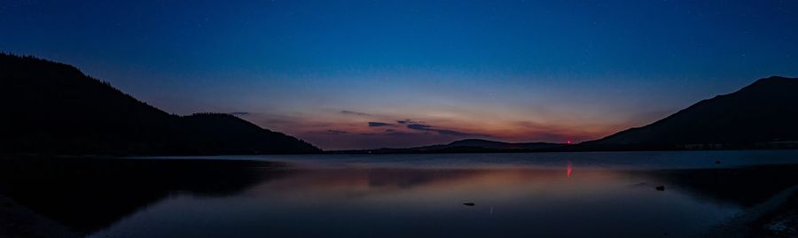 Scenic view of lake against sky at night