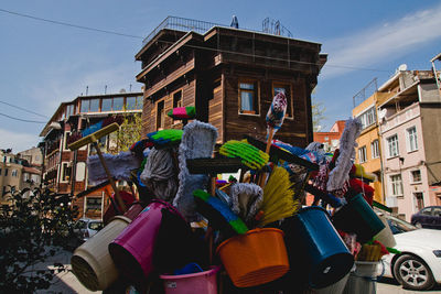 Rear view of people walking on street amidst buildings in city