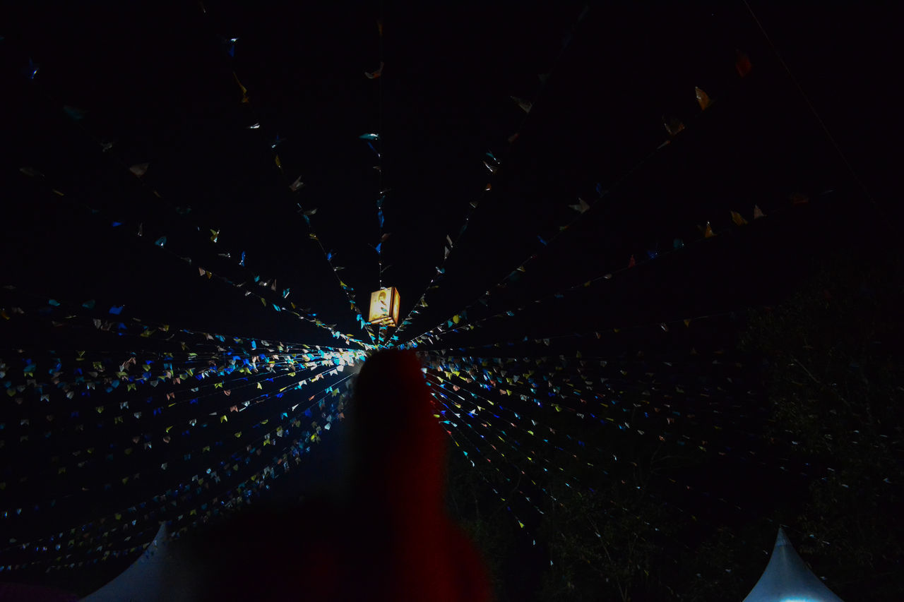 LIGHT TRAILS ON ILLUMINATED TUNNEL AT NIGHT