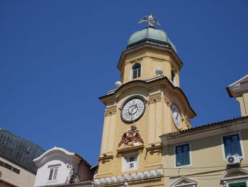 Low angle view of clock tower against clear sky