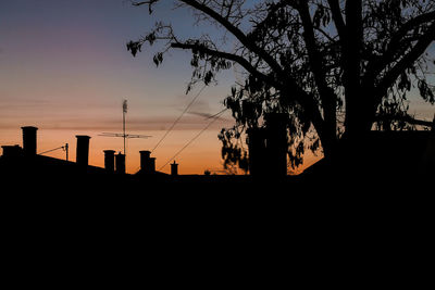 Silhouette trees against sky during sunset