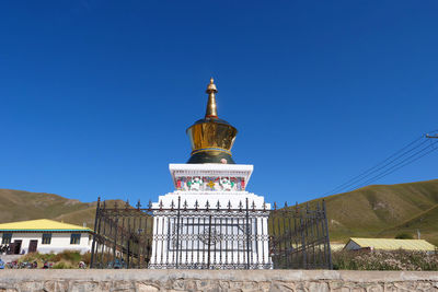 Low angle view of building against clear blue sky