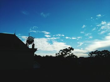 Low angle view of silhouette trees against sky