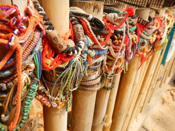 High angle view of bracelets on bamboos for sale at market stall