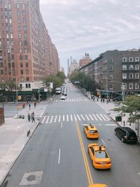 Traffic on road in new york city with yellow cabs.