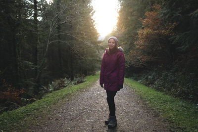 Woman standing in forest