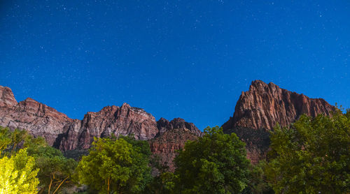 Scenic view of mountains against blue sky