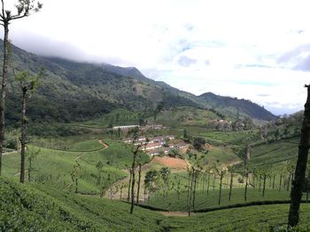 Scenic view of field and mountains against sky