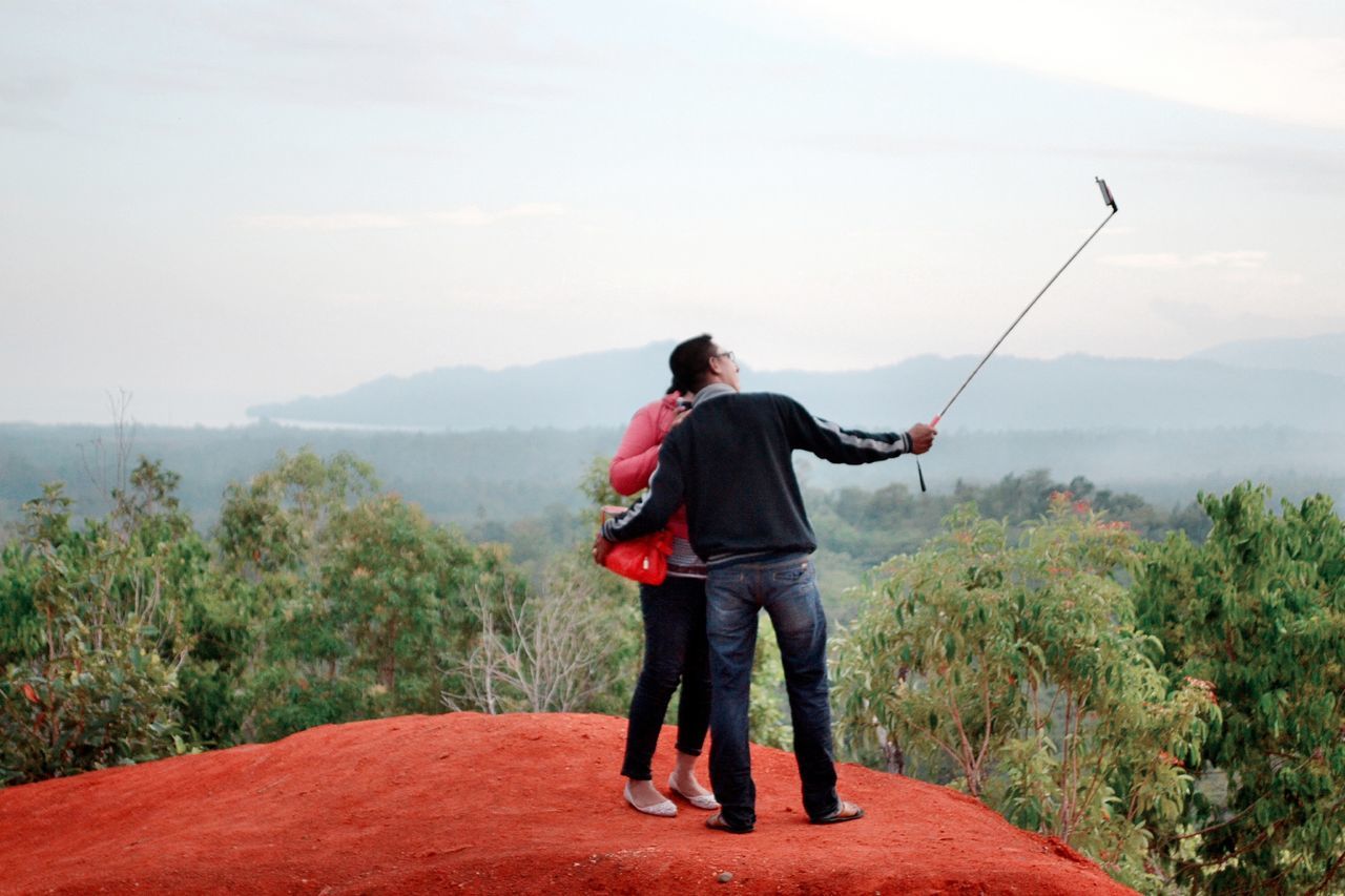 rear view, full length, leisure activity, lifestyles, mountain, casual clothing, men, standing, person, walking, tranquil scene, backpack, tranquility, nature, scenics, sky, mountain range, beauty in nature