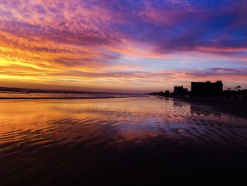 Scenic view of sea against orange sky