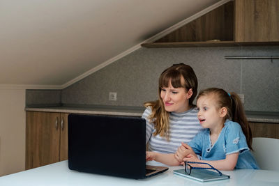 Portrait of a girl sitting on laptop