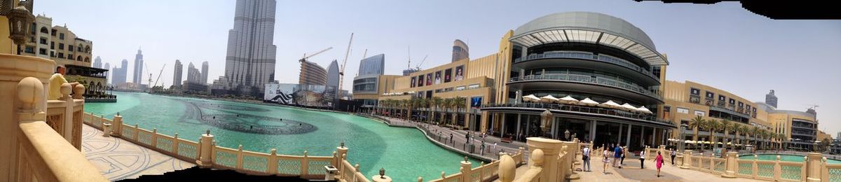 Panoramic view of people in city against sky