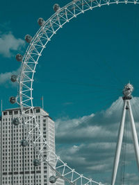 Low angle view of ferris wheel against blue sky