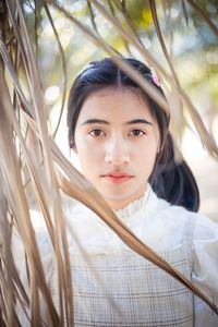 Portrait of woman by plants