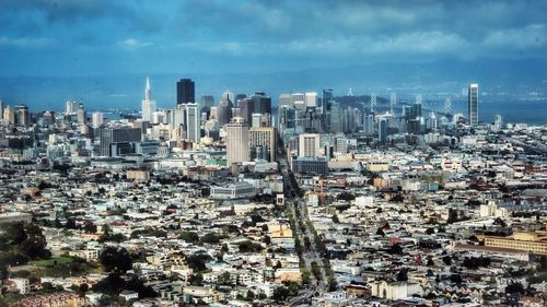 Cityscape against cloudy sky