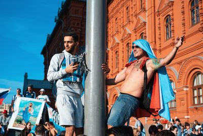 Low angle view of woman with arms raised