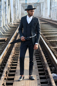 Full length of man standing at railroad station