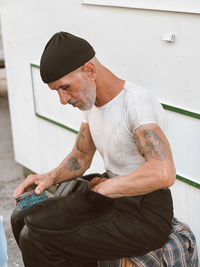 Side view of young man using mobile phone