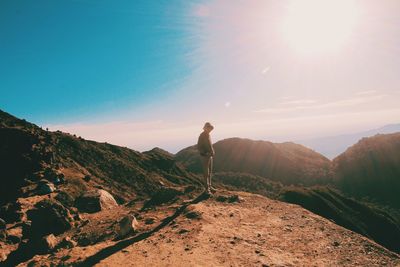 Man standing on mountain against sky