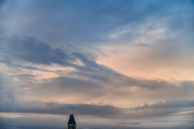 Low angle view of building against dramatic sky