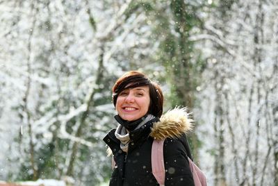 Portrait of smiling young woman in snow