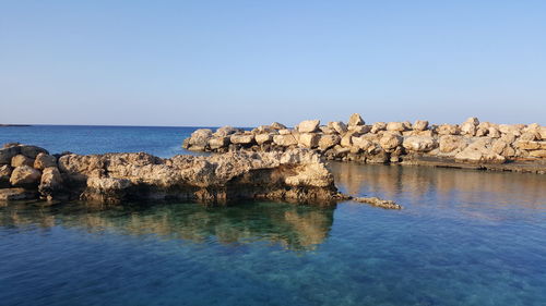 Scenic view of sea against clear blue sky