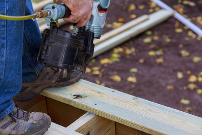 Low section of man working on wood