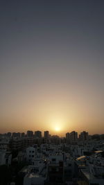 Cityscape against sky during sunset