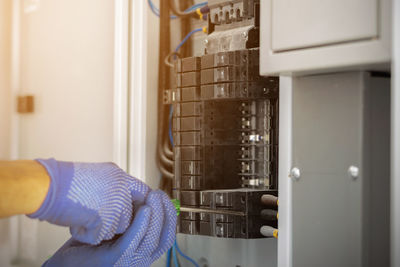 Cropped hand of electrician working with screw driver