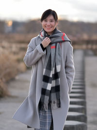 Portrait of a smiling young woman standing outdoors