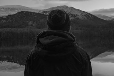 Rear view of man standing against mountains