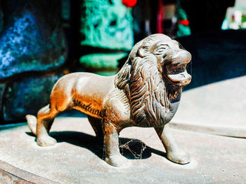 Close-up of lion statue on footpath