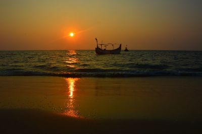 Scenic view of sea against orange sky