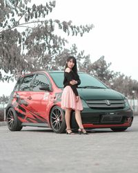 Full length of woman standing on car