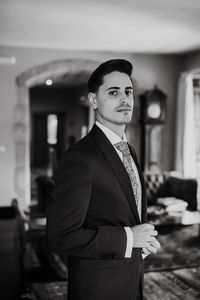 Portrait of young man standing at home