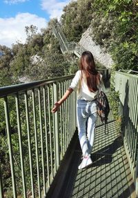 Girl walking on the bridge, bridge on the mountains