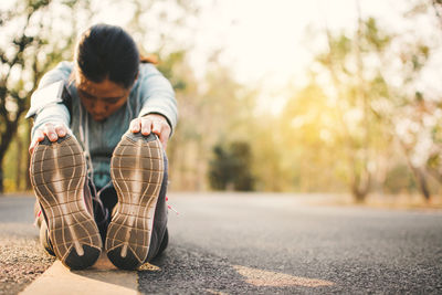 Young woman exercising on road