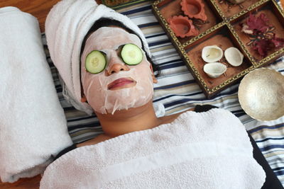 Woman using facial mask at home