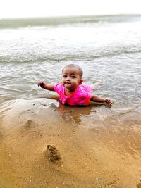 Portrait of cute girl relaxing at beach